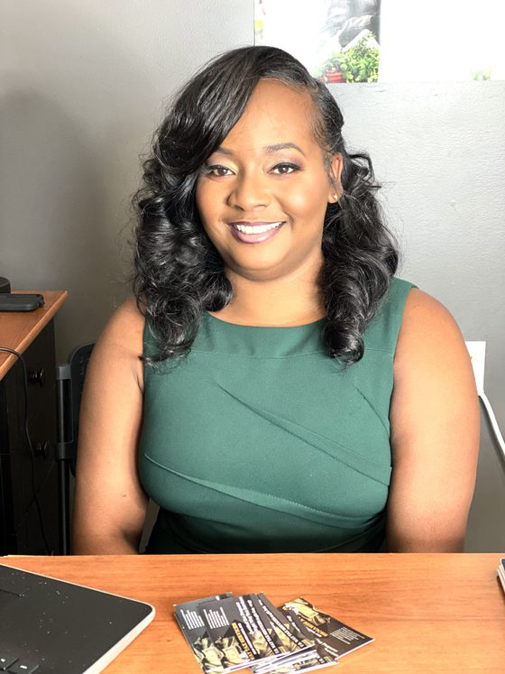 Tenisha Roby, owner of T.R. Way Tax Services, seated at her desk
